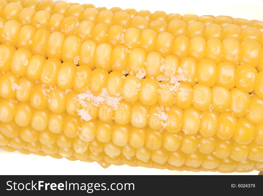 Corn with salt on white ground