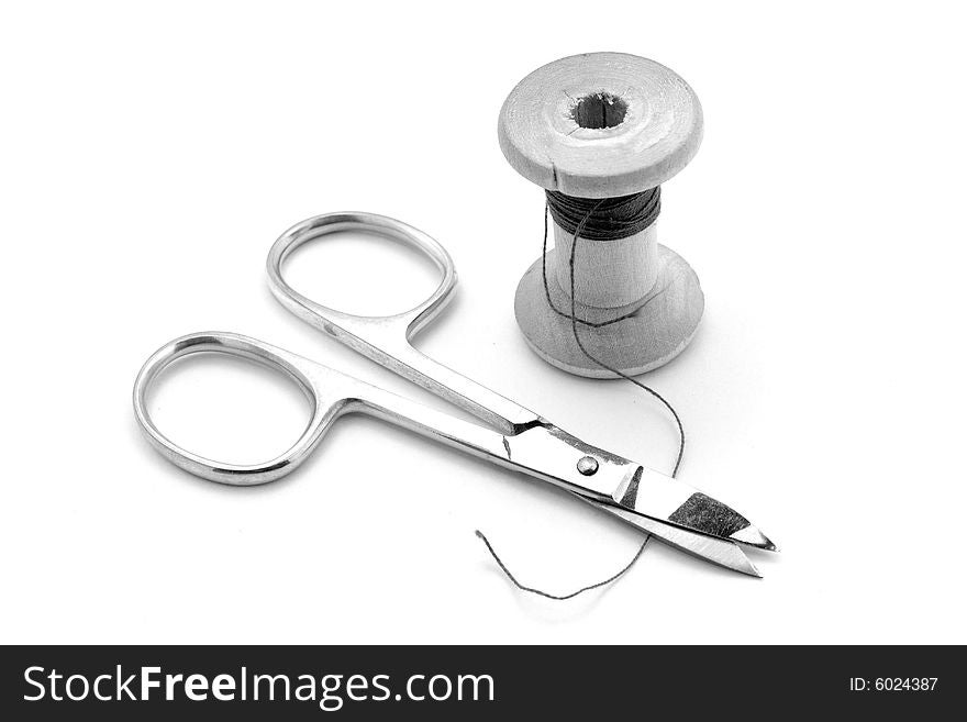 Isolated scissors and spool on white background