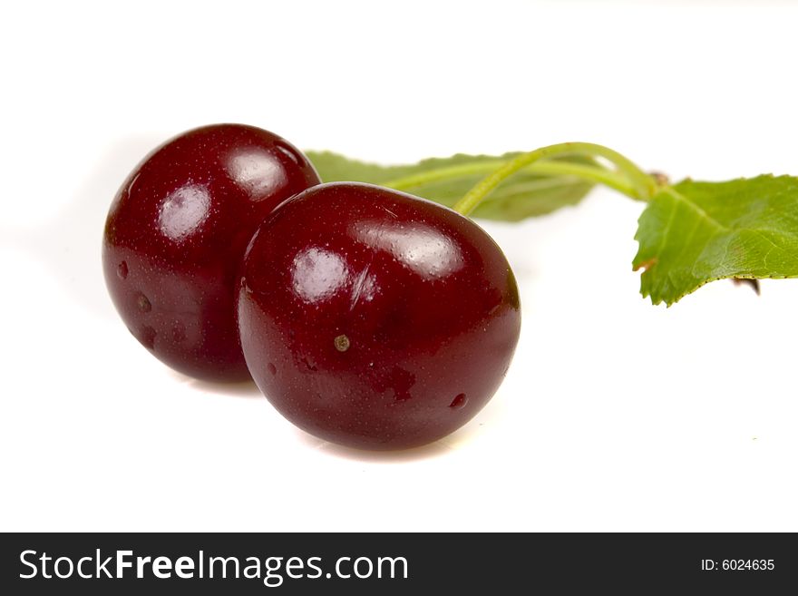 Isolated red cherries with leaves