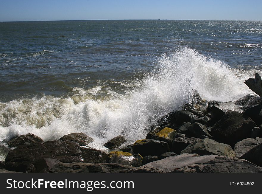 Ocean waves crashing in the rocks of the jetty near Ocean Shores Washington. Ocean waves crashing in the rocks of the jetty near Ocean Shores Washington.