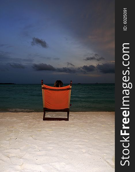 Nice vacation picture with woman sitting on a lounger. Nice vacation picture with woman sitting on a lounger