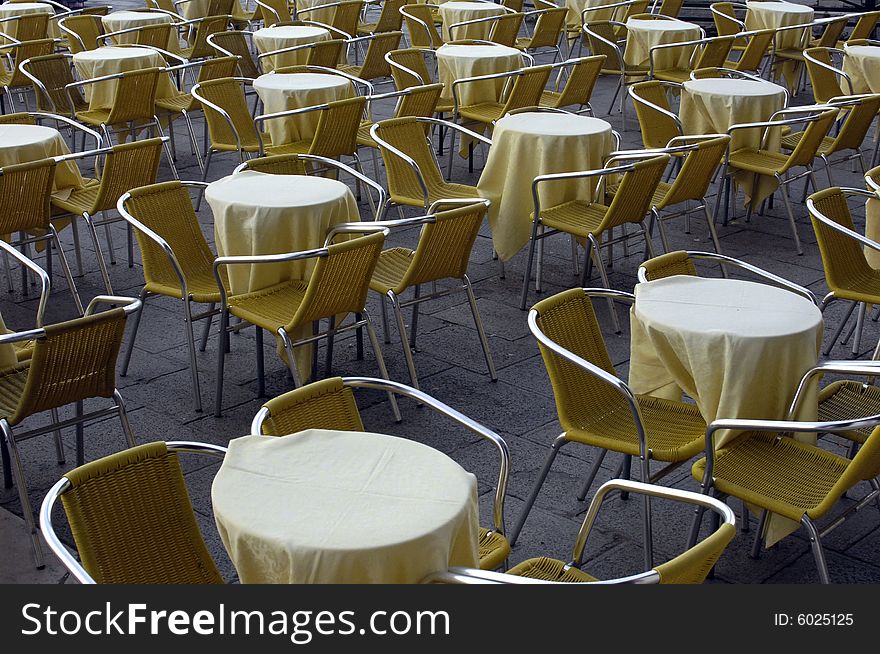 Tables and chairs at a terrace bar