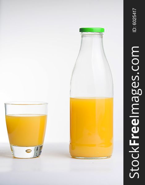 Orange juice, glass and bottle isolated over white
