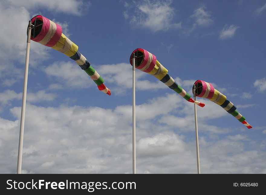 Coloured flags against the blue cloudy sky