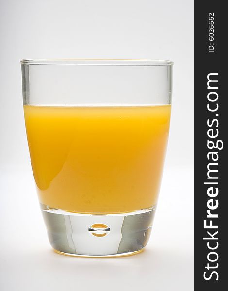 Orange juice glass isolated over white