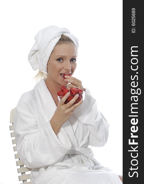 Young woman in spa area eats and enjoys strawberries. Young woman in spa area eats and enjoys strawberries