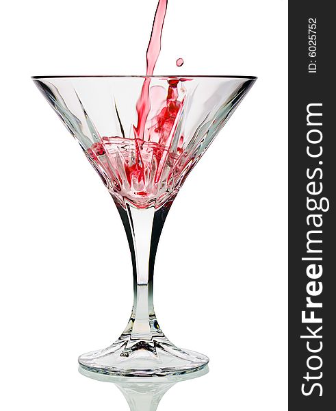 Pouring red cocktail into glass isolated against white background. Pouring red cocktail into glass isolated against white background