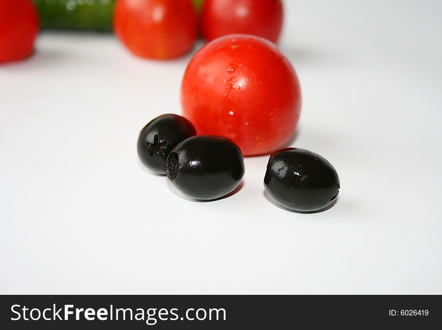 Tomato and olive on white backround