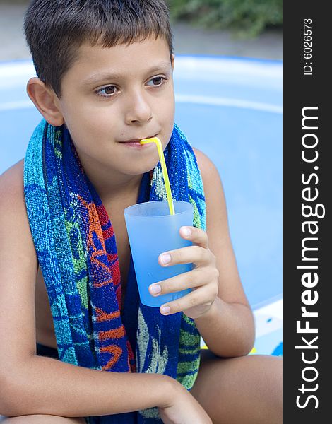 Cute young boy drink juice outdoor