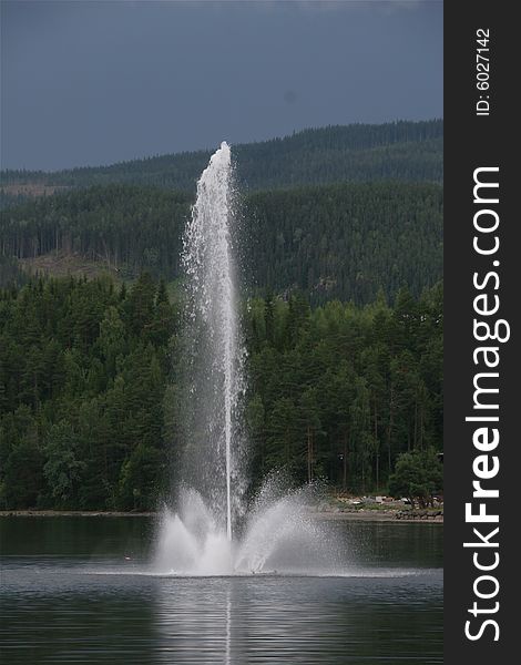 A lake with a big water fountain, Fagernes Norway. A lake with a big water fountain, Fagernes Norway