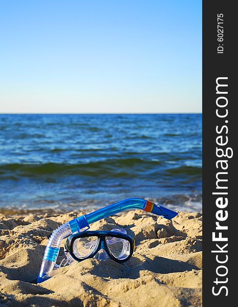 Snorkel equipment against beach and sky. Snorkel equipment against beach and sky