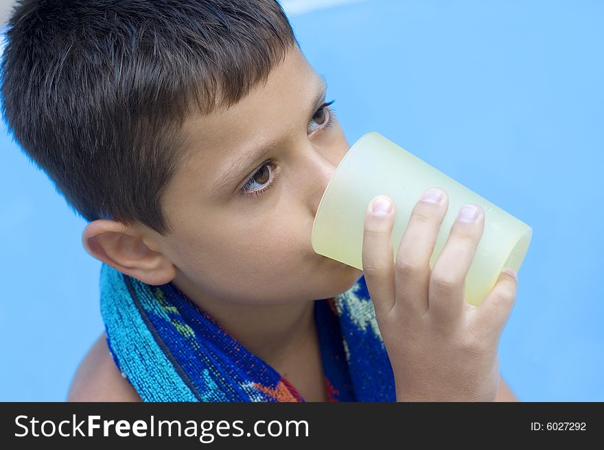 Cute young boy drink juice outdoor