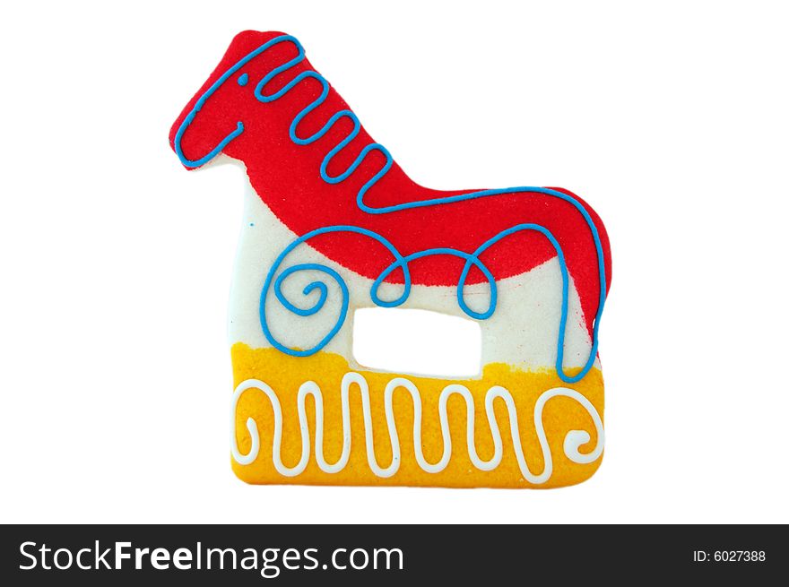 Horse shaped cookie, red and yellow isolated on white