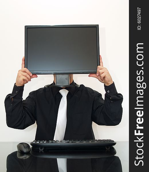 Businessman sitting on the desk, holding a computer monitor in hands. Businessman sitting on the desk, holding a computer monitor in hands