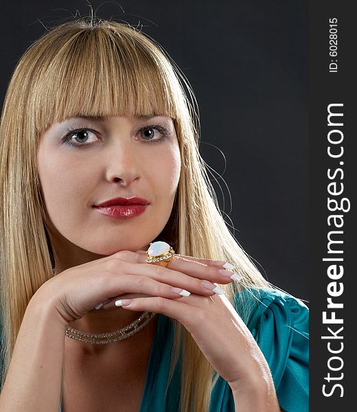 Portraite of blonde girl with jewelry looking straight