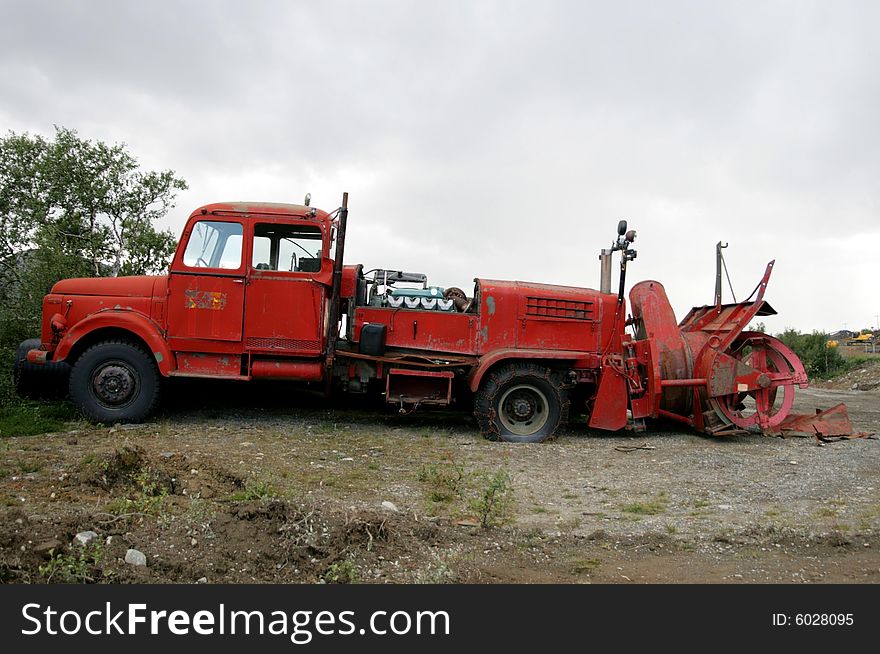 Old red lorry from the fifties with rotary snow cutter. Double cabin and three steering wheels. Old red lorry from the fifties with rotary snow cutter. Double cabin and three steering wheels.