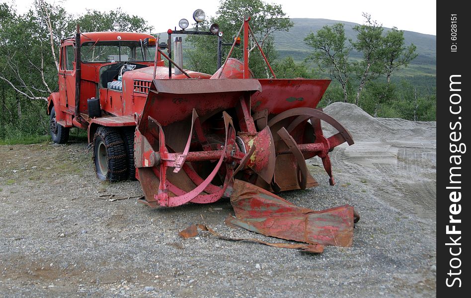 Old red lorry from the fifties with rotary snow cutter. Double cabin and three steering wheels. Old red lorry from the fifties with rotary snow cutter. Double cabin and three steering wheels.