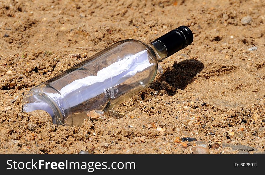 Shot of a washed up message in a bottle