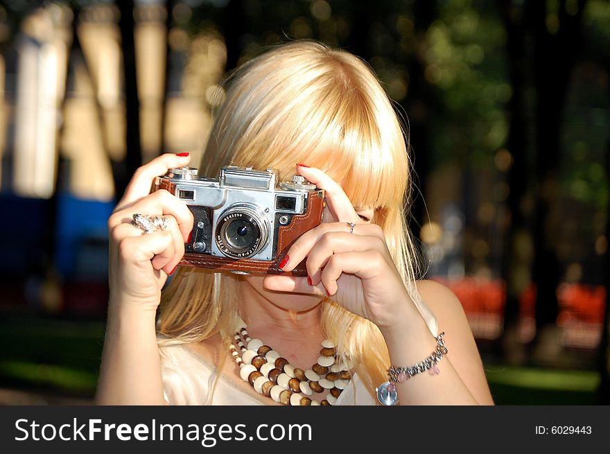 Girl with a camera taking a picture