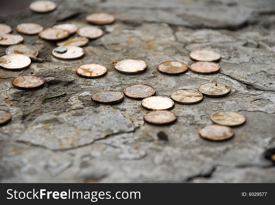 Old rusty coins on stones. Old rusty coins on stones