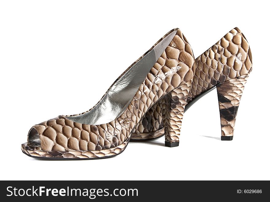 Beautiful fashionable female shoes from a leather on white background