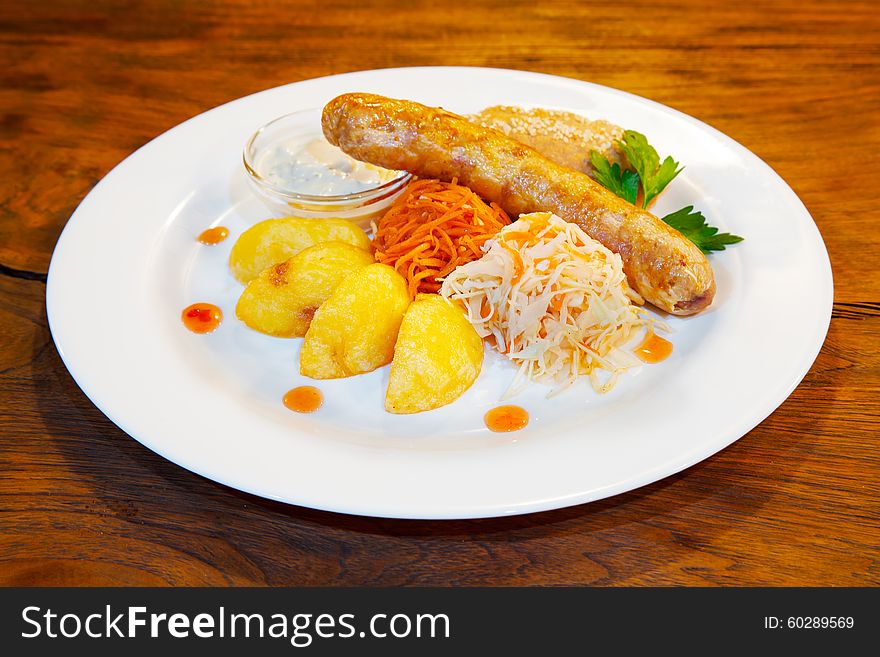 Fresh sausages with vegetables on a plate