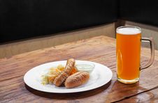 Sausages With Vegetables And Mug With Beer Stock Image