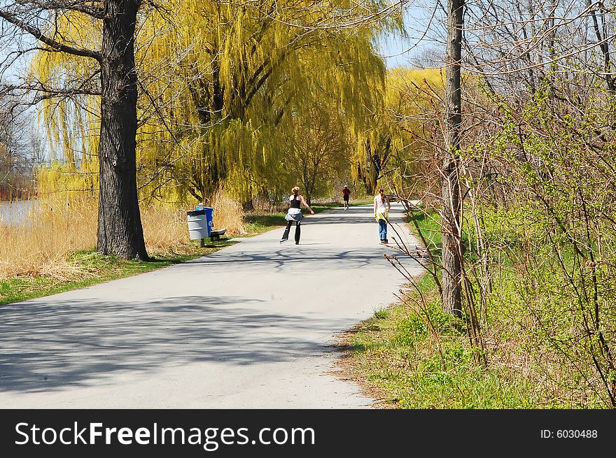 Nice sunny spring day and two girls on roller plates. Nice sunny spring day and two girls on roller plates.