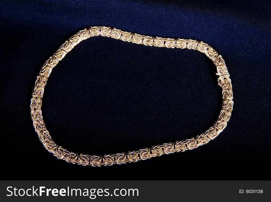 A necklace of a gold band on black background. A necklace of a gold band on black background