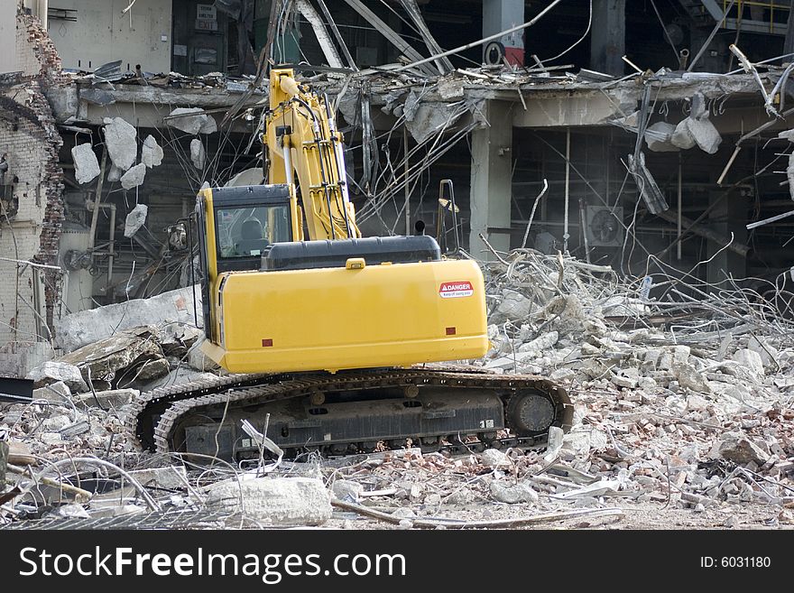 Excavator removing rubble of a building after demolition