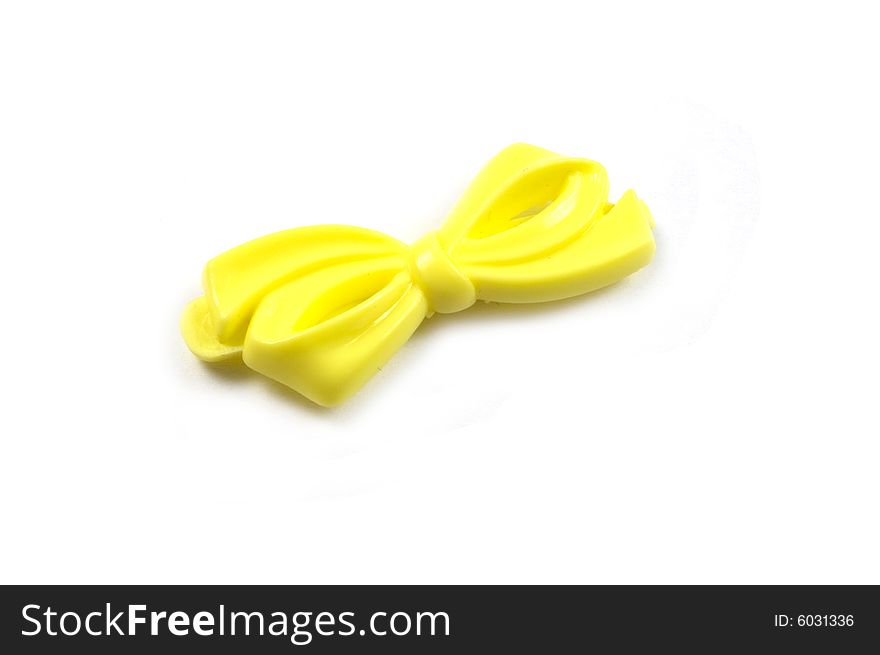 A photograph of a plastic bow against a white background