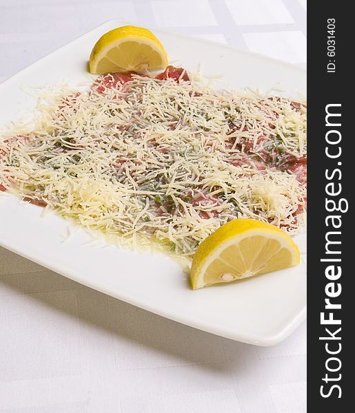 Salad with cheese and vegetables decorated with lemons