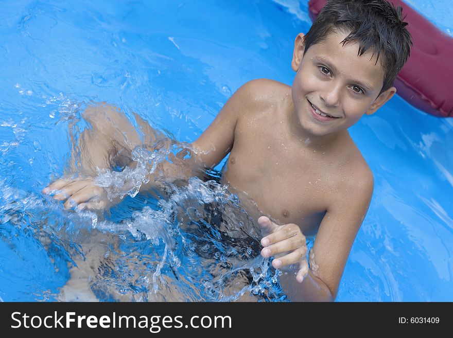 Portrait of young boy in pool