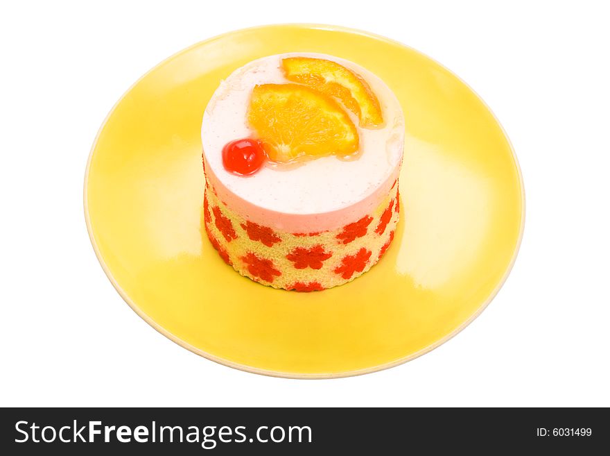 Cake with a cherry and an orange on a yellow plate