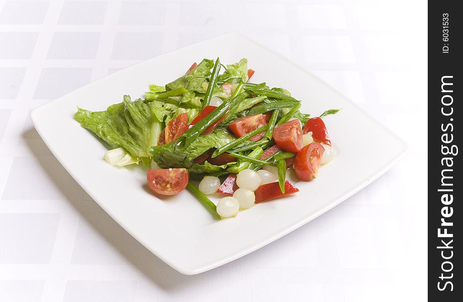 Salad with vegetables on white plate
