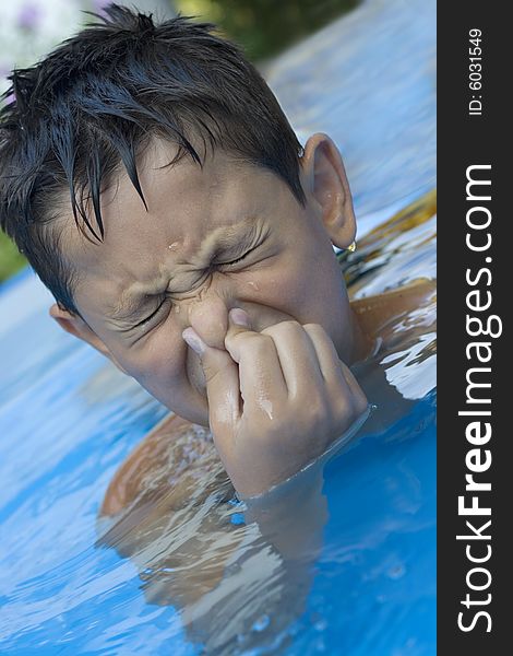 Portrait of young boy in pool