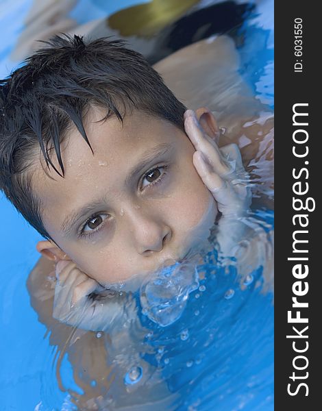 Portrait of young boy in pool