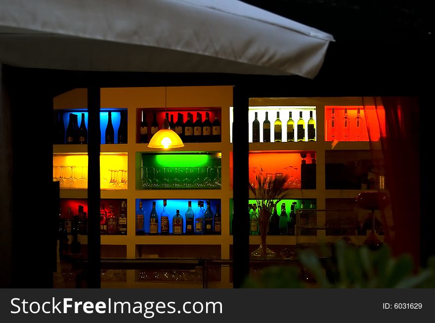 View of a set of illuminated bottles in a  bar of Via di Santa Cecilia, trastevere,  Roma, italy. View of a set of illuminated bottles in a  bar of Via di Santa Cecilia, trastevere,  Roma, italy
