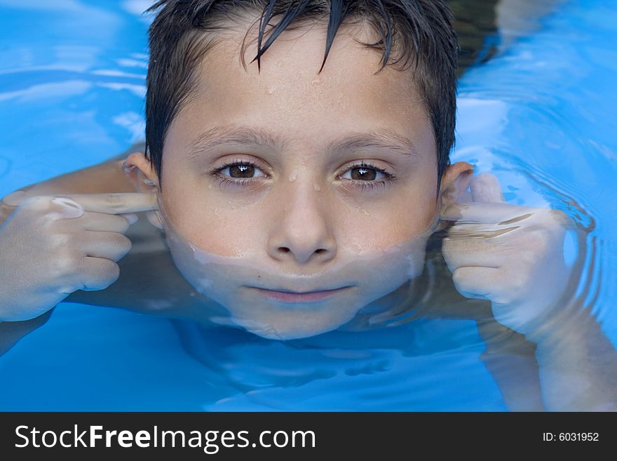 Portrait of young boy in pool