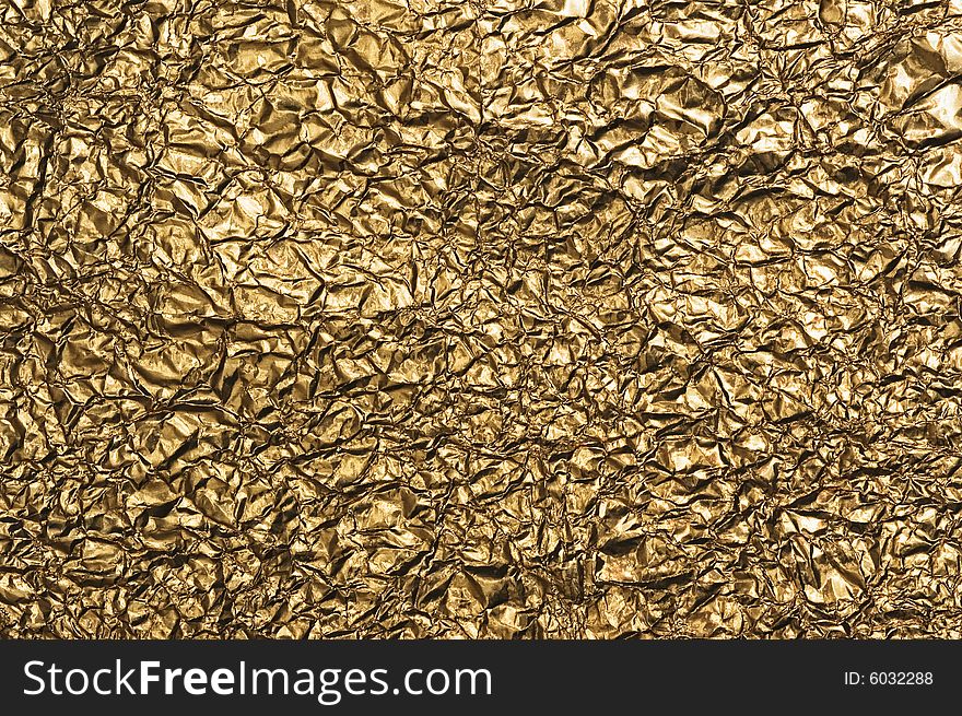 Gold metallic crumpled paper texture for background