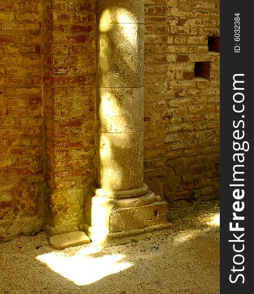 A suggestive shot of the light that plays on an ancient column in San Galgano abbey. A suggestive shot of the light that plays on an ancient column in San Galgano abbey