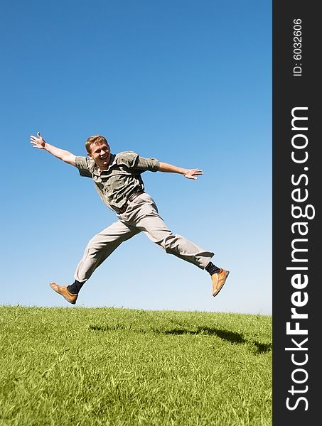 Happy jumping businessman on the hill. Happy jumping businessman on the hill