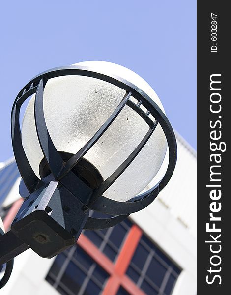 Macro close-up of urban style lantern in downtown Toronto with blue sky
