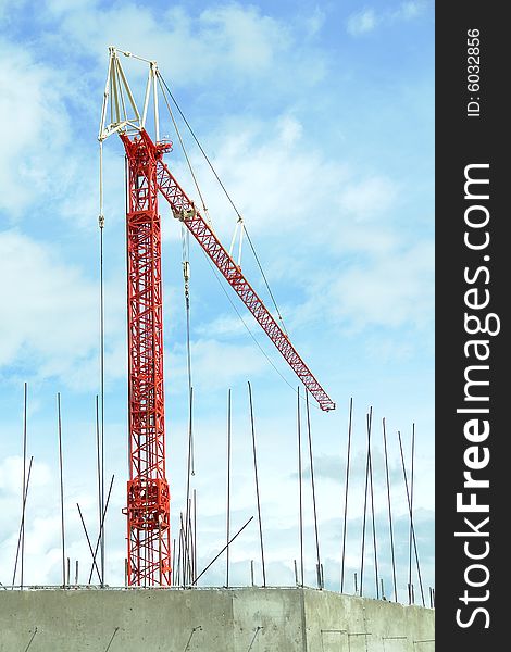 Bright red crane for heavy lifting on a construction site. Bright red crane for heavy lifting on a construction site