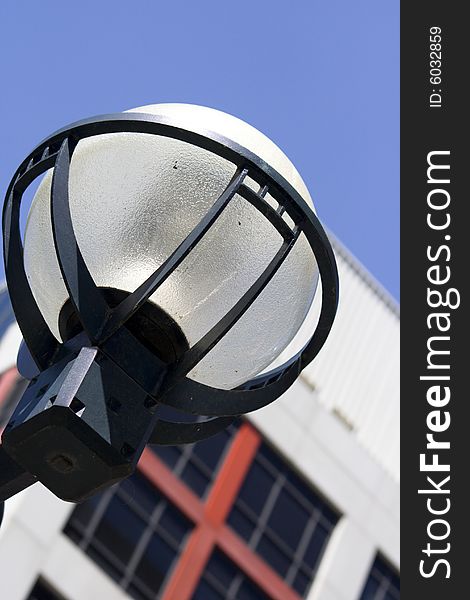 Macro close-up of urban style lantern in downtown Toronto with blue sky