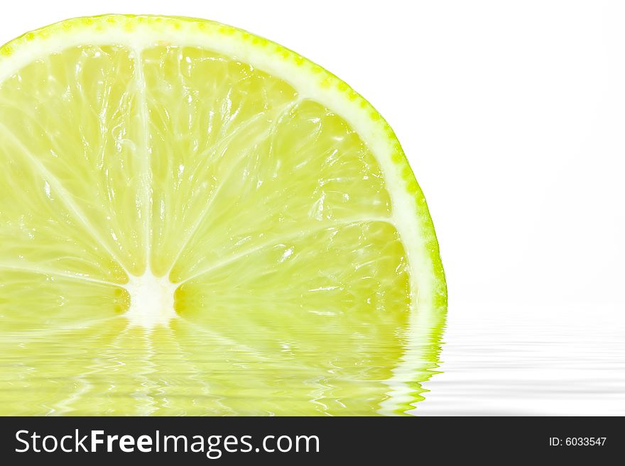 Fresh slice of lime on white with water reflection. Fresh slice of lime on white with water reflection