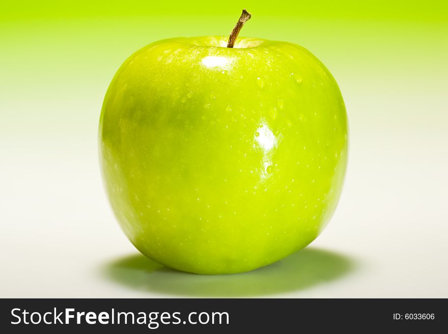 Fresh green apple with fresh gradient lighting and water droplets