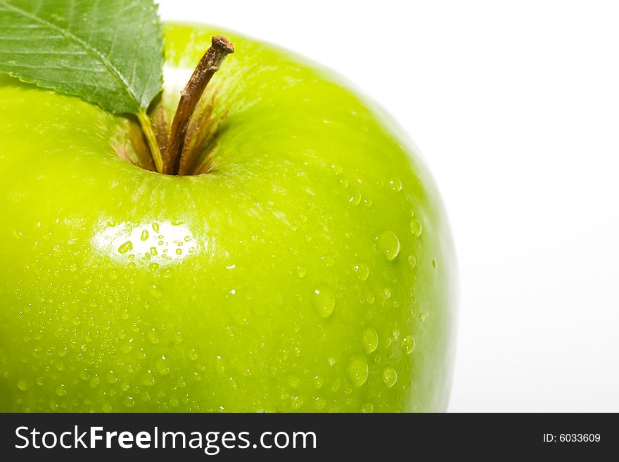 Fresh green apple isolated on white with water droplets