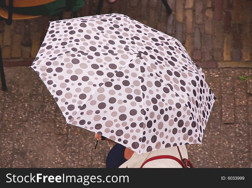 An umbrella with brown and grey spots. An umbrella with brown and grey spots