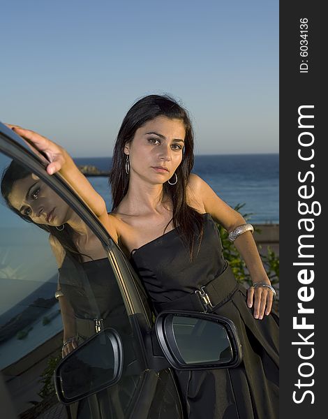 Young woman sitting on her new car